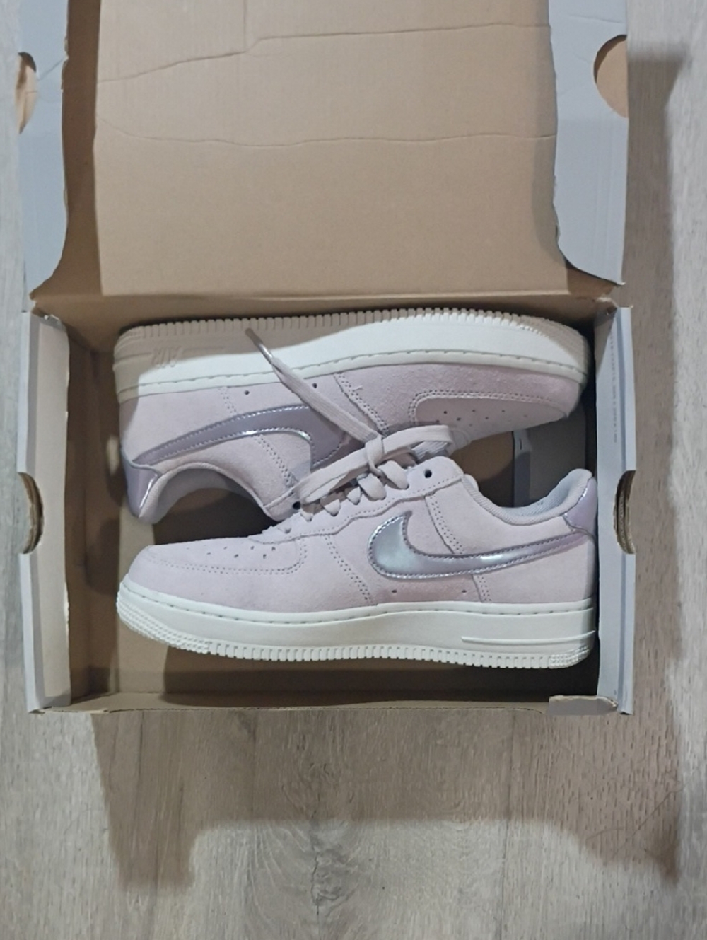 Nike Low-Top Sneakers in Pale Pink with Iridescent Swoosh